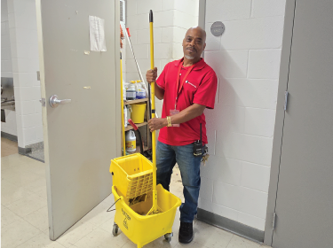 man holding mop and bucket